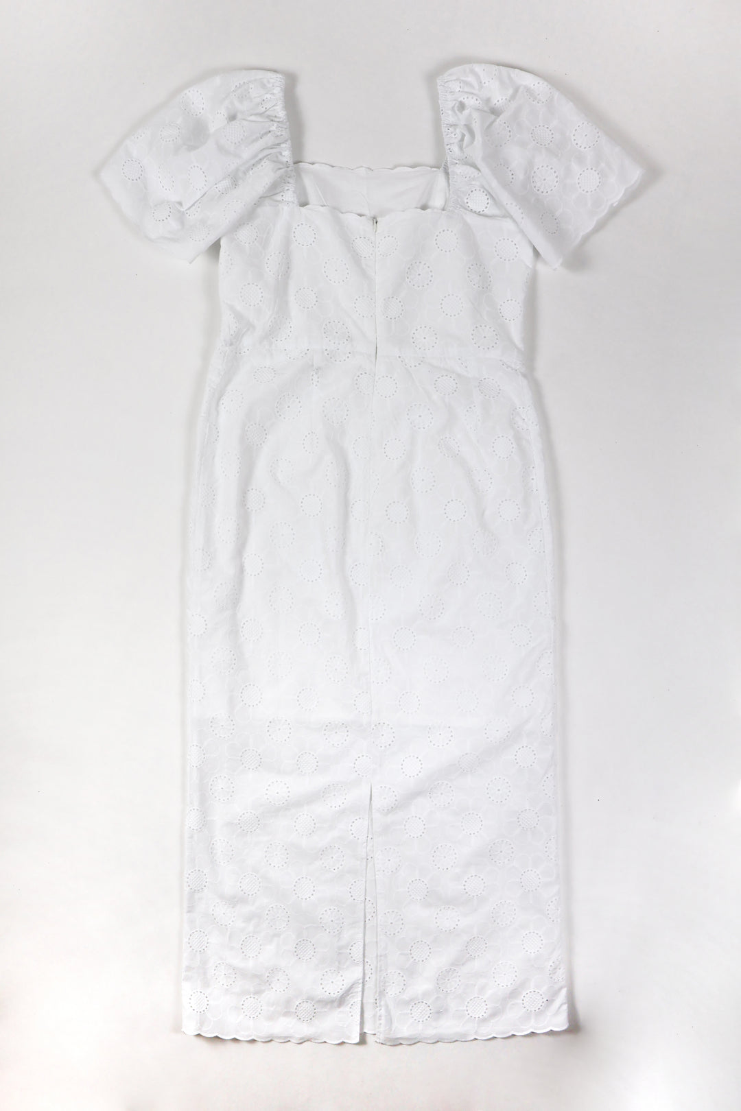 Dress with puffed and gathered sleeves. Invisible zipper closure at the back and opening at the bottom of the back.